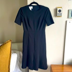 Black crew mini dress with sleeve slit detail
